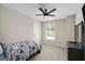 Relaxing bedroom with a window view, fan and a cool space themed comforter at 1478 Interlaken Pass, Jonesboro, GA 30238