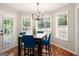 Bright dining area with large windows, a modern chandelier, and seating for four at 1478 Interlaken Pass, Jonesboro, GA 30238