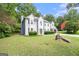 Beautiful home featuring mature trees and landscaping, a side-entry garage, and a spacious front yard at 1478 Interlaken Pass, Jonesboro, GA 30238