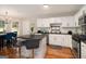 Kitchen featuring white cabinets, stainless steel appliances, island with seating, and hardwood floors at 1478 Interlaken Pass, Jonesboro, GA 30238