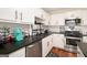 This kitchen has white cabinets, stainless steel appliances, and black countertops at 1478 Interlaken Pass, Jonesboro, GA 30238