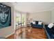 Bright living room featuring hardwood floors, bay windows, and stylish blue sofas at 1478 Interlaken Pass, Jonesboro, GA 30238