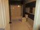 Small bathroom featuring a shower and toilet, with striped accent wall at 4382 Highway 42 S, Locust Grove, GA 30248