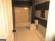 Bathroom featuring a shower-tub combination, toilet, and black and white striped accent wall at 4382 Highway 42 S, Locust Grove, GA 30248