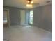 Large bedroom features a window, ceiling fan, and neutral walls at 4382 Highway 42 S, Locust Grove, GA 30248