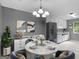 Stylish dining area with modern furniture, a chandelier, and an adjacent kitchen area at 4382 Highway 42 S, Locust Grove, GA 30248