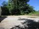 Backyard showing a concrete driveway that needs repair at 4382 Highway 42 S, Locust Grove, GA 30248