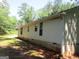 Home's exterior featuring light-colored siding and green lawn at 4382 Highway 42 S, Locust Grove, GA 30248