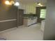 Spacious kitchen with white cabinets, granite countertops, and a window over the sink at 4382 Highway 42 S, Locust Grove, GA 30248