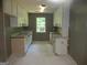 Spacious kitchen with white cabinets, granite countertops, and a window over the sink at 4382 Highway 42 S, Locust Grove, GA 30248
