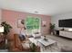 Inviting living room featuring a comfortable sofa, a cozy chair, and modern decor at 4382 Highway 42 S, Locust Grove, GA 30248
