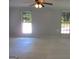 Open living room with a ceiling fan and natural lighting at 4382 Highway 42 S, Locust Grove, GA 30248