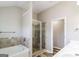 Bright bathroom featuring a shower, tub, double vanity, and tile accents at 2577 Shropshire Pl, Mcdonough, GA 30253