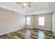 This bedroom features windows for natural light and wood-look flooring at 2577 Shropshire Pl, Mcdonough, GA 30253