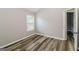 An empty bedroom featuring hardwood floors and a neutral color palette at 2577 Shropshire Pl, Mcdonough, GA 30253