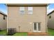 The back of a 2-story home featuring two windows and a set of double doors at 2577 Shropshire Pl, Mcdonough, GA 30253