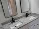 Bathroom featuring granite countertop, modern mirrors, lighting, and fixtures at 3339 Clevemont Ct, Ellenwood, GA 30294