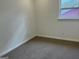 Bright bedroom features neutral walls, carpet, and a window letting in natural light at 3339 Clevemont Ct, Ellenwood, GA 30294