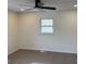 Bright bedroom features neutral walls, carpet, modern ceiling fan, and a window letting in natural light at 3339 Clevemont Ct, Ellenwood, GA 30294