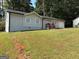 The home has a well-maintained lawn and a gray brick exterior at 3339 Clevemont Ct, Ellenwood, GA 30294