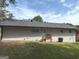 Rear exterior view of the home with a well-maintained yard and a patio area accessible from the back door at 3339 Clevemont Ct, Ellenwood, GA 30294