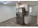 View of the kitchen including stainless steel refrigerator and granite countertops at 3339 Clevemont Ct, Ellenwood, GA 30294