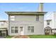 View of the rear exterior of the home featuring siding, a door, and windows at 1577 Keystone Dr, Conley, GA 30288
