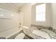 Well-lit bathroom features a shower-tub combination and granite-topped vanity at 1577 Keystone Dr, Conley, GA 30288