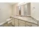 Bathroom featuring a mirror, a white toilet, and a granite-topped vanity at 1577 Keystone Dr, Conley, GA 30288