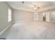 Spacious carpeted bedroom with ceiling fan and natural light from multiple windows at 1577 Keystone Dr, Conley, GA 30288