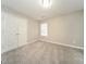 Neutral bedroom with a closet, carpeted floors, and a window at 1577 Keystone Dr, Conley, GA 30288