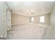 Large carpeted bedroom with ceiling fan and multiple windows for ample lighting at 1577 Keystone Dr, Conley, GA 30288