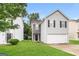 Attractive two-story home with stone accent, gray siding and well manicured lawn at 1577 Keystone Dr, Conley, GA 30288