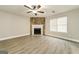 Bright living room with wood grain floors, stone fireplace, and ceiling fan at 1577 Keystone Dr, Conley, GA 30288