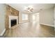 Spacious living room with a stone fireplace, ceiling fan, and wood grain flooring at 1577 Keystone Dr, Conley, GA 30288
