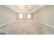 Spacious carpeted main bedroom with ceiling fan and natural light from multiple windows at 1577 Keystone Dr, Conley, GA 30288