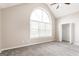 Spacious bedroom with arched window, ceiling fan, carpet, and walk-in closet at 182 Spivey Glen Dr, Jonesboro, GA 30236