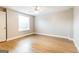 Bright bedroom features wood floors, neutral walls, ceiling fan, and a window at 182 Spivey Glen Dr, Jonesboro, GA 30236