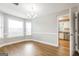 Bright dining room featuring beautiful floors, a chandelier, and an open view into the kitchen at 182 Spivey Glen Dr, Jonesboro, GA 30236