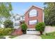 Beautiful two-story brick and white-sided home with a well-manicured lawn, and an attached garage at 182 Spivey Glen Dr, Jonesboro, GA 30236