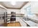 Well-lit kitchen featuring stainless steel appliances, granite countertops, and white cabinetry at 182 Spivey Glen Dr, Jonesboro, GA 30236