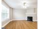 Bright living room featuring beautiful floors, a cozy fireplace, ceiling fan, and ample natural light at 182 Spivey Glen Dr, Jonesboro, GA 30236
