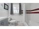 Clean bathroom with tiled walls, modern fixtures, and a window, providing a functional and pleasant space at 1226 Pine Knoll, Conyers, GA 30013