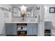 Bright bathroom with stylish blue vanity, quartz countertop, and modern fixtures, offering a clean and fresh aesthetic at 1226 Pine Knoll, Conyers, GA 30013
