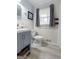 Classic bathroom with gray vanity and tiled accents, featuring updated fixtures for a comfortable and stylish experience at 1226 Pine Knoll, Conyers, GA 30013