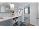 Well-appointed bathroom featuring blue vanity, quartz countertop, and modern decor, offering a blend of style and functionality at 1226 Pine Knoll, Conyers, GA 30013