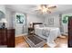 Charming bedroom with hardwood floors, a ceiling fan, and natural light, perfect for relaxation and rest at 1226 Pine Knoll, Conyers, GA 30013