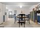 Inviting dining area with modern light fixture, wainscoting, and a view to the kitchen at 1226 Pine Knoll, Conyers, GA 30013