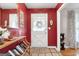 Foyer with a bright red accent wall, tile flooring and a white front door at 1226 Pine Knoll, Conyers, GA 30013