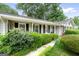 The exterior showcases mature landscaping and a walkway leading to the covered entrance at 1226 Pine Knoll, Conyers, GA 30013